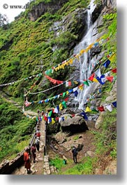 asia, asian, bhutan, buddhist, flags, green, hikers, hiking, lush, nature, people, prayer flags, religious, vertical, water, waterfalls, photograph