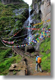 asia, bhutan, bridge, buddhist, flags, hikers, lush, nature, prayer flags, religious, vertical, water, waterfalls, photograph