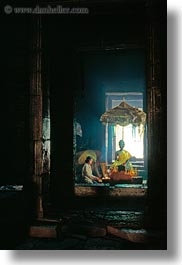 angkor thom, asia, bayon, buddhas, cambodia, candles, lighting, vertical, womens, photograph