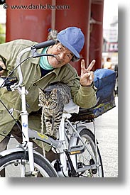 asia, bicycles, cats, japan, men, people, vertical, photograph