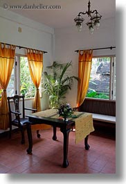 asia, buildings, chairs, hotels, laos, luang prabang, nature, palm trees, plants, structures, tables, trees, vertical, windows, photograph