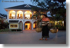 archways, asia, buildings, carrying, don ganh, dusk, glow, horizontal, hotels, laos, lights, luang prabang, structures, womens, photograph
