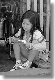 asia, asian, black and white, childrens, eating, girls, laos, luang prabang, people, vertical, yellow, photograph