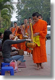 alms, asia, asian, colors, giving, giving alms, laos, luang prabang, men, monks, oranges, people, procession, vertical, womens, photograph