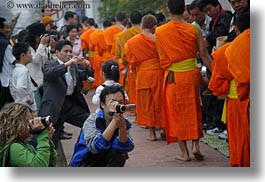 asia, asian, cameras, colors, horizontal, laos, luang prabang, men, monks, oranges, people, photographing, procession, photograph