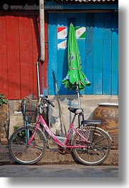 asia, bicycles, bikes, green, laos, luang prabang, pink, transportation, umbrellas, vertical, photograph