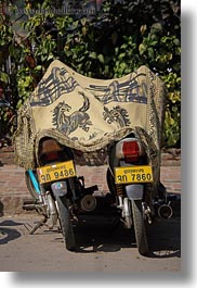 asia, bikes, horses, laos, luang prabang, motorcycles, rugs, transportation, two, under, vertical, photograph