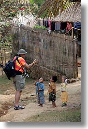 asia, backpack, cameras, childrens, clothes, hats, hmong, laos, people, photographers, talking, toddlers, tourists, vertical, villages, photograph
