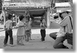 asia, asian, black and white, cameras, clothes, emotions, hats, horizontal, laos, laugh, men, people, photographing, river village, smiles, toddlers, tourists, villages, photograph