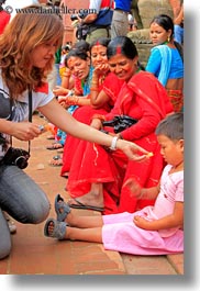 asia, childrens, emotions, feeding, kathmandu, nepal, patan darbur square, photographers, smiles, vertical, womens, photograph