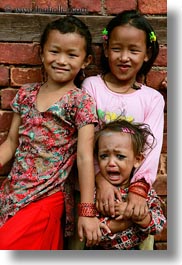 asia, babies, crying, emotions, girls, kathmandu, nepal, patan darbur square, smiles, smiling, vertical, womens, photograph