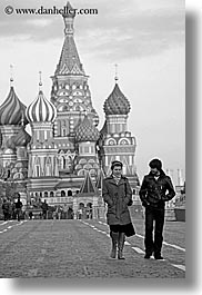 asia, black and white, buildings, churches, couples, landmarks, moscow, near, onion dome, pedestrians, people, pokrovskiy, religious, russia, st basil, st basil cathedral, st. basil, structures, vertical, walking, photograph