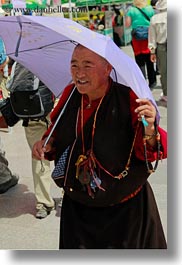 asia, emotions, lhasa, old, people, purple, smiles, tibet, umbrellas, vertical, womens, photograph
