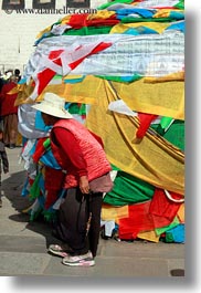 asia, buddhist, flags, lhasa, old, people, prayer flags, prayers, religious, tibet, vertical, walking, womens, photograph