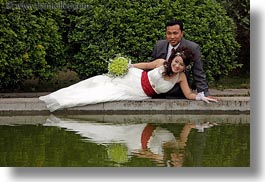 asia, brides, brooms, couples, flowers, hanoi, horizontal, people, reclining, vietnam, water, photograph