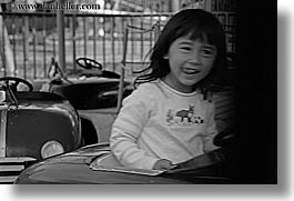amusement park ride, asian, black and white, california, cars, childrens, driving, girls, happy, horizontal, oakland zoo, people, west coast, western usa, photograph