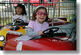amusement park ride, california, cars, childrens, driving, girls, glasses, happy, horizontal, oakland zoo, people, west coast, western usa, photograph