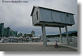 bicycles, bikes, canada, horizontal, houses, people, stilts, vancouver, photograph