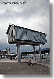 bicycles, bikes, canada, houses, people, stilts, vancouver, vertical, photograph