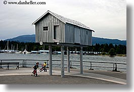 bicycles, bikes, boys, canada, childrens, horizontal, houses, people, stilts, vancouver, photograph