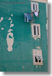 blues, buildings, colors, cres, croatia, europe, green, jeans, laundry, vertical, photograph