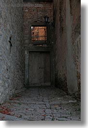 cobblestones, croatia, doors, europe, groznjan, materials, narrow streets, roads, stones, streets, vertical, windows, photograph
