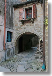 arches, archways, cobblestones, croatia, europe, groznjan, materials, narrow streets, roads, stones, streets, structures, vertical, windows, photograph