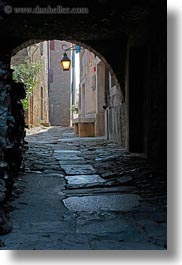 arches, archways, cobblestones, croatia, europe, groznjan, materials, narrow streets, roads, stones, streets, structures, vertical, photograph