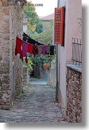 cobblestones, croatia, europe, hangings, laundry, materials, motovun, narrow, narrow streets, stones, streets, towns, vertical, photograph