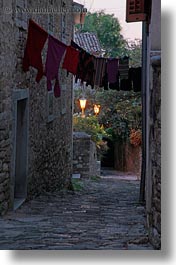 cobblestones, croatia, europe, glow, hangings, laundry, lights, materials, motovun, narrow, narrow streets, stones, streets, towns, vertical, photograph
