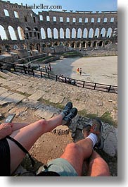 amphitheater, architectural ruins, archways, buildings, croatia, europe, legs, pula, roman, structures, vertical, photograph