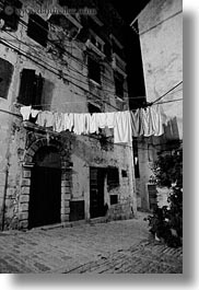 black and white, clothes, cobblestones, croatia, europe, hangings, laundry, materials, narrow streets, rovinj, stones, streets, vertical, photograph