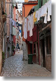 clothes, cobblestones, croatia, europe, hangings, laundry, materials, narrow, narrow streets, rovinj, stones, streets, vertical, photograph
