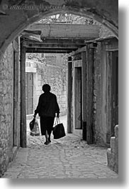 bags, black and white, carrying, croatia, europe, narrow streets, streets, trogir, vertical, womens, photograph