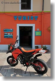 colorful, colors, croatia, europe, motorcycles, oranges, signs, tourists, veli losinj, vertical, photograph
