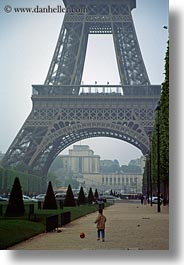 boys, buildings, eiffel tower, europe, france, haze, paris, playing, soccer, structures, towers, vertical, photograph