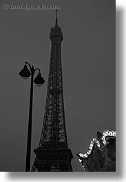 black and white, buildings, dusk, eiffel tower, europe, france, glow, lamp posts, lights, paris, structures, towers, vertical, photograph