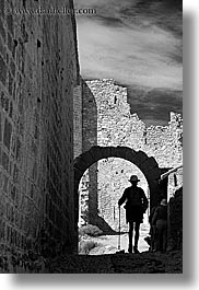 archways, bargeme, black and white, buildings, castles, europe, france, hikers, hiking, materials, men, people, provence, silhouettes, stones, structures, vertical, photograph