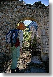 activities, architectural ruins, archways, europe, france, hikers, hiking, looking, people, provence, structures, vertical, photograph