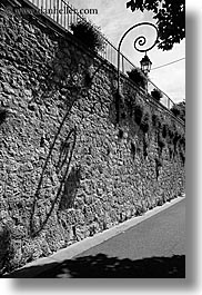 black and white, europe, france, lamps, materials, moustiers, provence, shadows, st marie, stones, streets, vertical, photograph