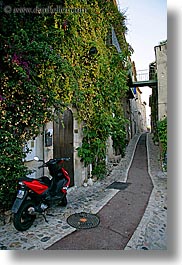 bougainvilleas, cobblestones, colors, europe, flowers, france, green, ivy, materials, motorcycles, narrow, nature, plants, provence, red, st paul, streets, vertical, photograph