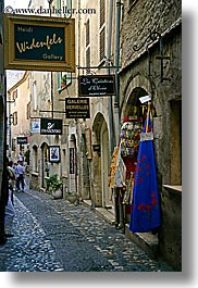 cobblestones, europe, france, materials, narrow, provence, st paul, stones, storefronts, streets, vertical, photograph