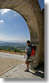 arches, archways, backpack, clothes, clouds, colors, europe, france, groups, men, nature, nicos, people, provence, red, sky, structures, sunglasses, vertical, photograph