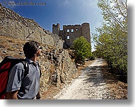 activities, architectural ruins, backpack, buildings, castles, clothes, colors, europe, fortress, france, groups, hiking, horizontal, men, nicos, people, provence, red, structures, sunglasses, viewing, photograph