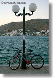 amorgos, bicycles, europe, greece, lamp posts, ocean, vertical, photograph