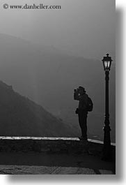 amorgos, black and white, europe, greece, lamp posts, mountains, people, photographers, vertical, photograph