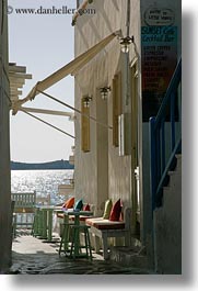 benches, buildings, colorful, europe, greece, mykonos, pillows, vertical, photograph