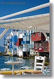 buildings, chairs, europe, flowers, greece, mykonos, tables, vertical, waterfront, photograph