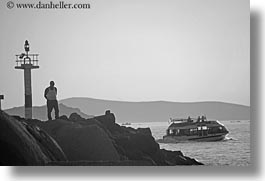 black and white, boats, europe, greece, horizontal, men, mykonos, rocks, watching, photograph