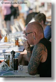 clothes, drinks, earrings, europe, glasses, greece, men, mykonos, people, tattoo, vertical, photograph